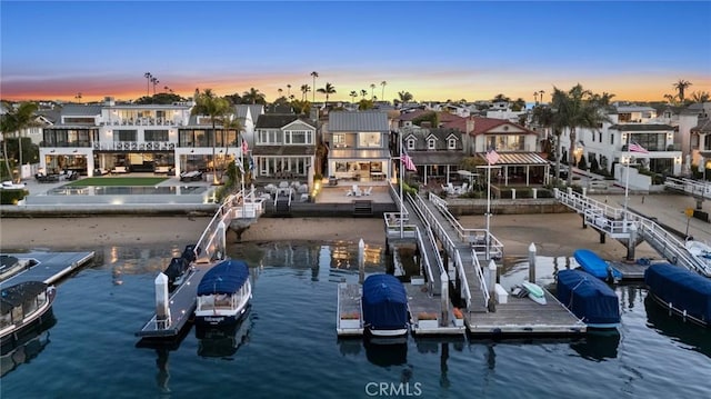 view of dock featuring a water view and a residential view