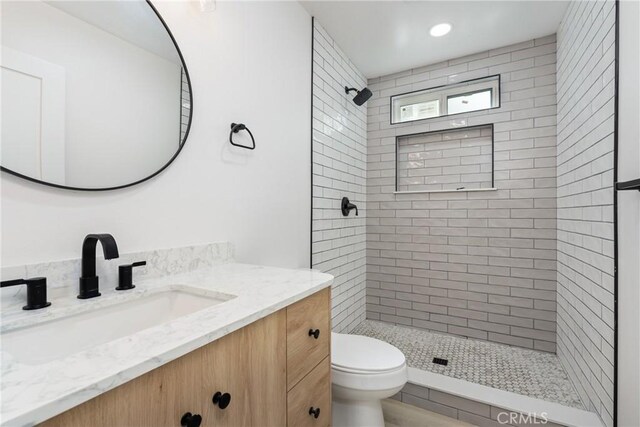 full bathroom with recessed lighting, vanity, toilet, and a shower stall