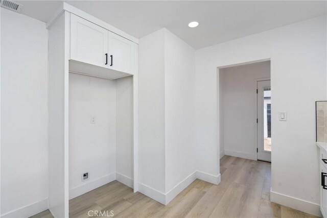 laundry area with recessed lighting, light wood-type flooring, visible vents, and baseboards