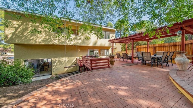 view of patio with fence, outdoor dining space, and a pergola