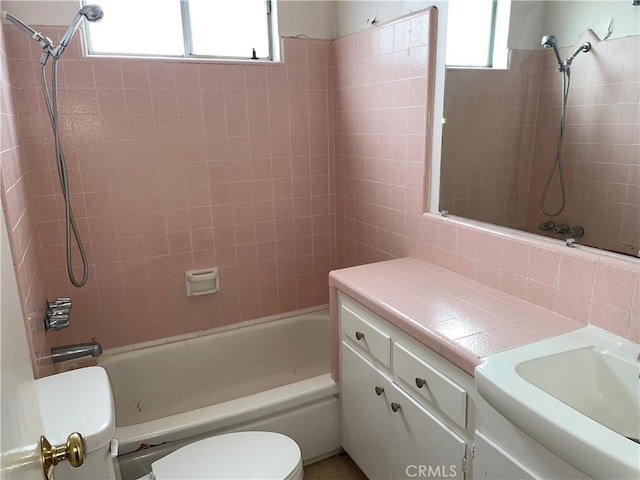 bathroom featuring toilet, washtub / shower combination, and vanity