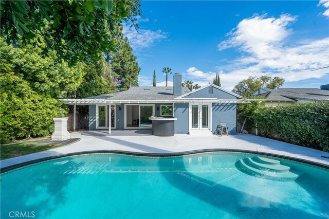 back of property with a patio, fence, and stucco siding