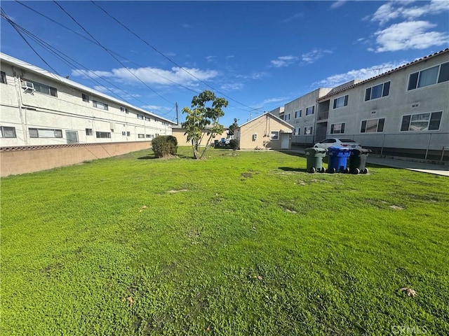 view of yard featuring fence and a residential view