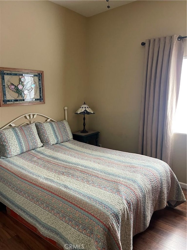 bedroom featuring dark wood finished floors