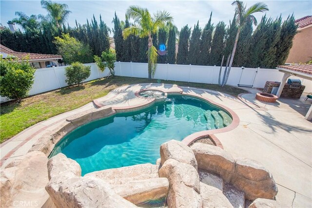 view of pool with a patio area, a fenced backyard, a fire pit, and a fenced in pool