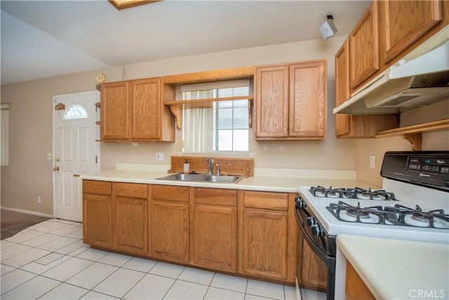 kitchen with range with gas stovetop, light countertops, under cabinet range hood, open shelves, and a sink