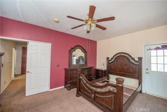 carpeted bedroom with ceiling fan and baseboards