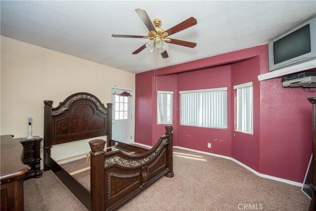 bedroom featuring carpet floors, baseboards, and a ceiling fan