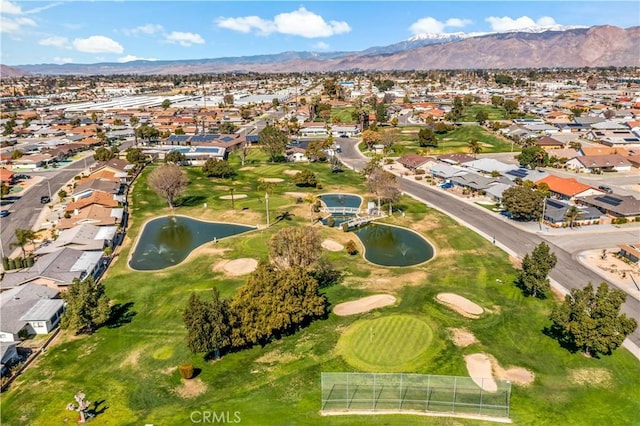 bird's eye view featuring view of golf course, a residential view, and a water and mountain view