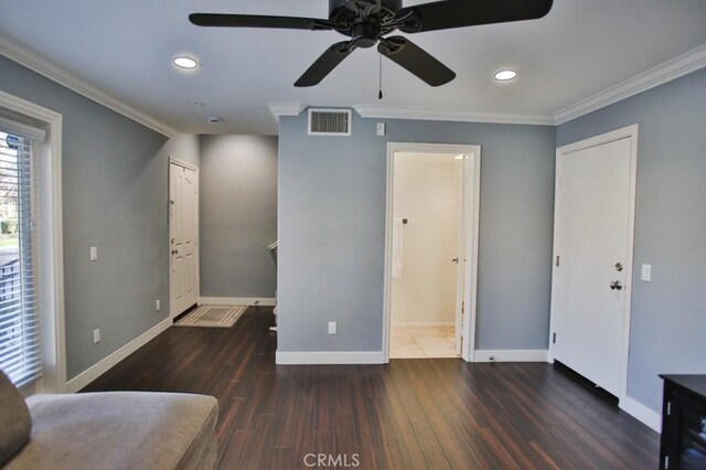 bedroom with dark wood-style flooring, visible vents, and crown molding