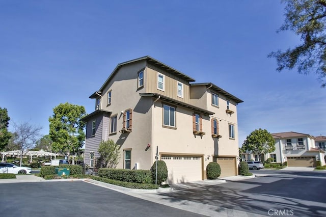 264 Blue Sky Dr, Tustin, CA 92782 - view of property exterior featuring stucco siding and a garage