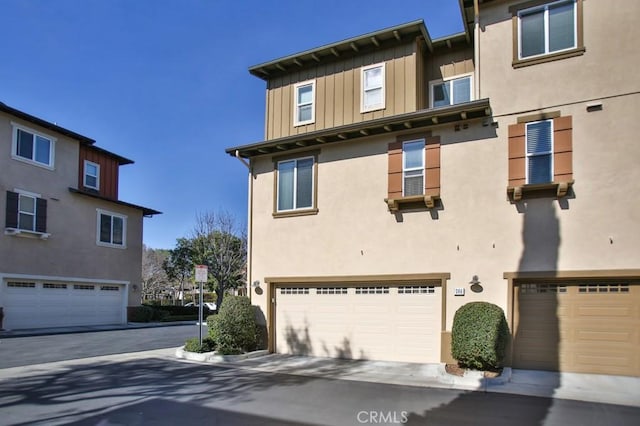 264 Blue Sky Dr, Tustin, CA 92782 - townhome / multi-family property with board and batten siding, stucco siding, and a garage