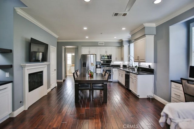 264 Blue Sky Dr, Tustin, CA 92782 - kitchen with dark countertops, visible vents, appliances with stainless steel finishes, and dark wood-style floors