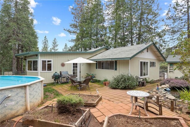 back of house with a patio and an outdoor pool