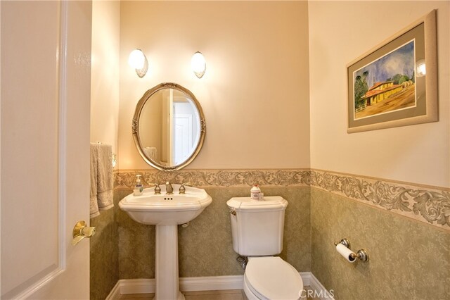 bathroom with wainscoting and toilet