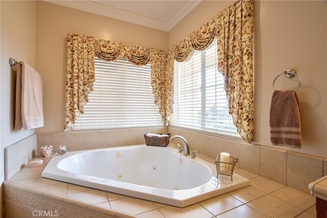 bathroom with a tub with jets, ornamental molding, and a wealth of natural light