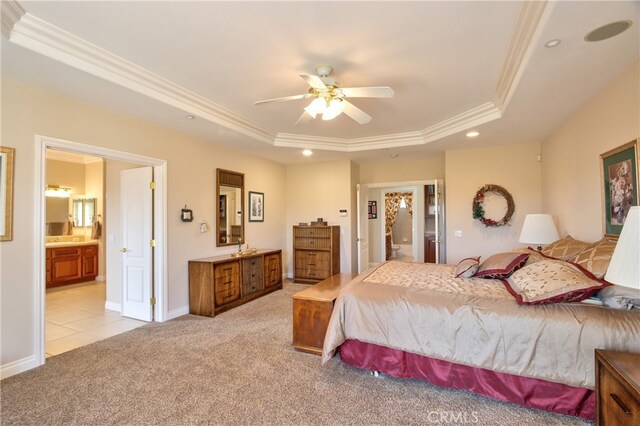 bedroom featuring a raised ceiling, light colored carpet, ensuite bath, crown molding, and recessed lighting