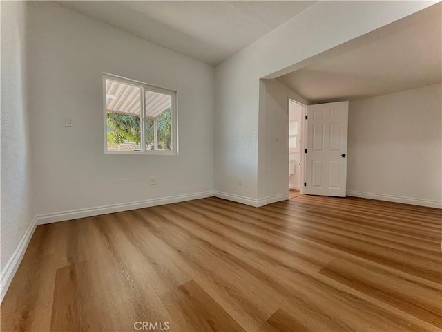 unfurnished room with light wood finished floors and baseboards