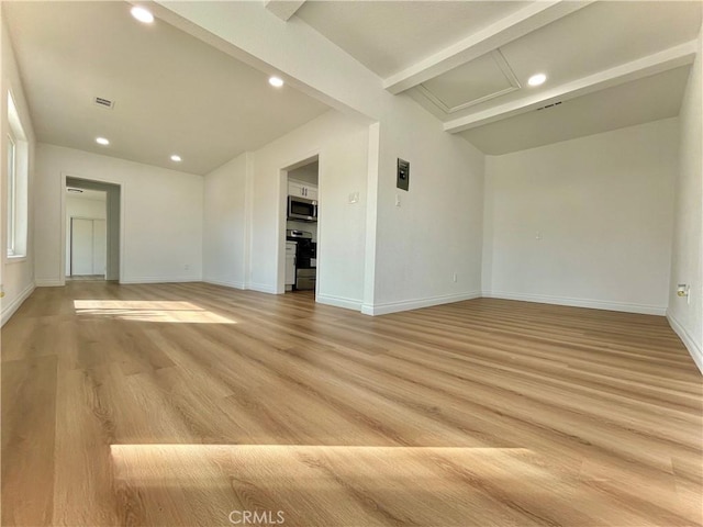 spare room with light wood finished floors, visible vents, baseboards, beamed ceiling, and recessed lighting