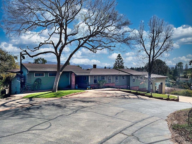 single story home featuring concrete driveway