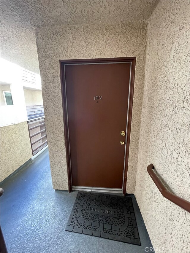 10115 Pinewood Ave Unit 102, Tujunga, CA 91042 - doorway to property featuring stucco siding