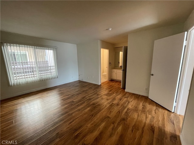 10115 Pinewood Ave Unit 102, Tujunga, CA 91042 - unfurnished bedroom with dark wood-style floors and ensuite bath