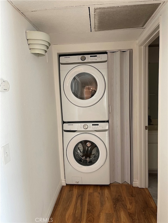 10115 Pinewood Ave Unit 102, Tujunga, CA 91042 - laundry area featuring stacked washer / drying machine and wood finished floors