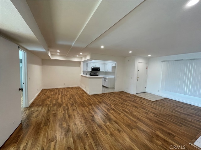 10115 Pinewood Ave Unit 102, Tujunga, CA 91042 - unfurnished living room with wood finished floors and recessed lighting
