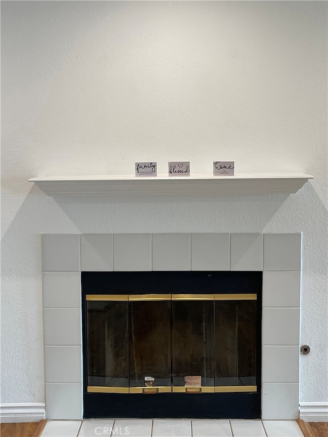 10115 Pinewood Ave Unit 102, Tujunga, CA 91042 - detailed view of a tiled fireplace, wood finished floors, and a textured wall