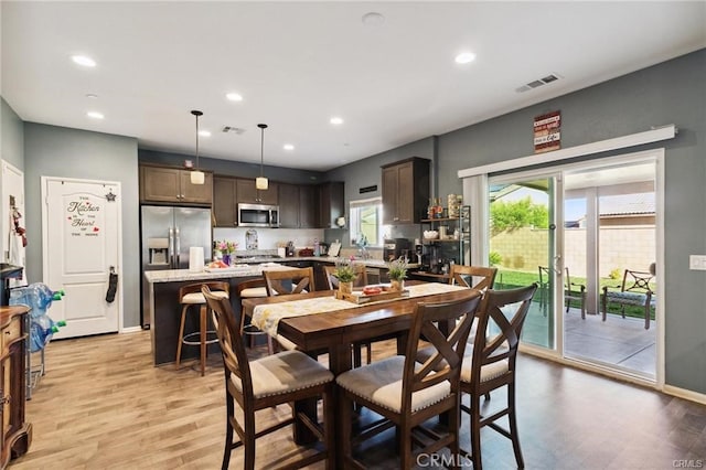 dining room featuring recessed lighting, baseboards, visible vents, and light wood finished floors