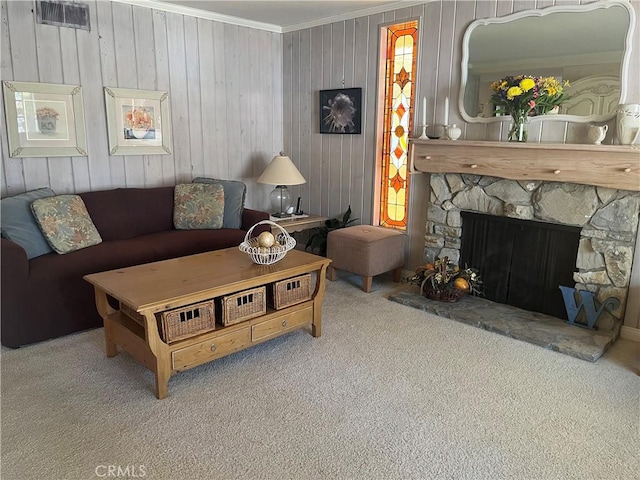 carpeted living area with visible vents, crown molding, and a stone fireplace