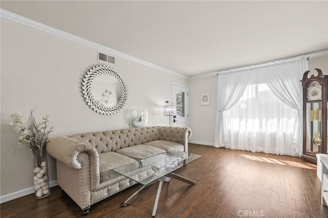 living area with ornamental molding, dark wood finished floors, visible vents, and baseboards