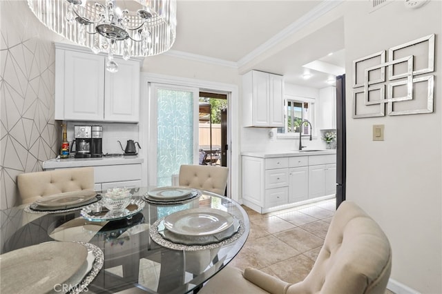 dining area featuring an inviting chandelier, light tile patterned floors, and ornamental molding