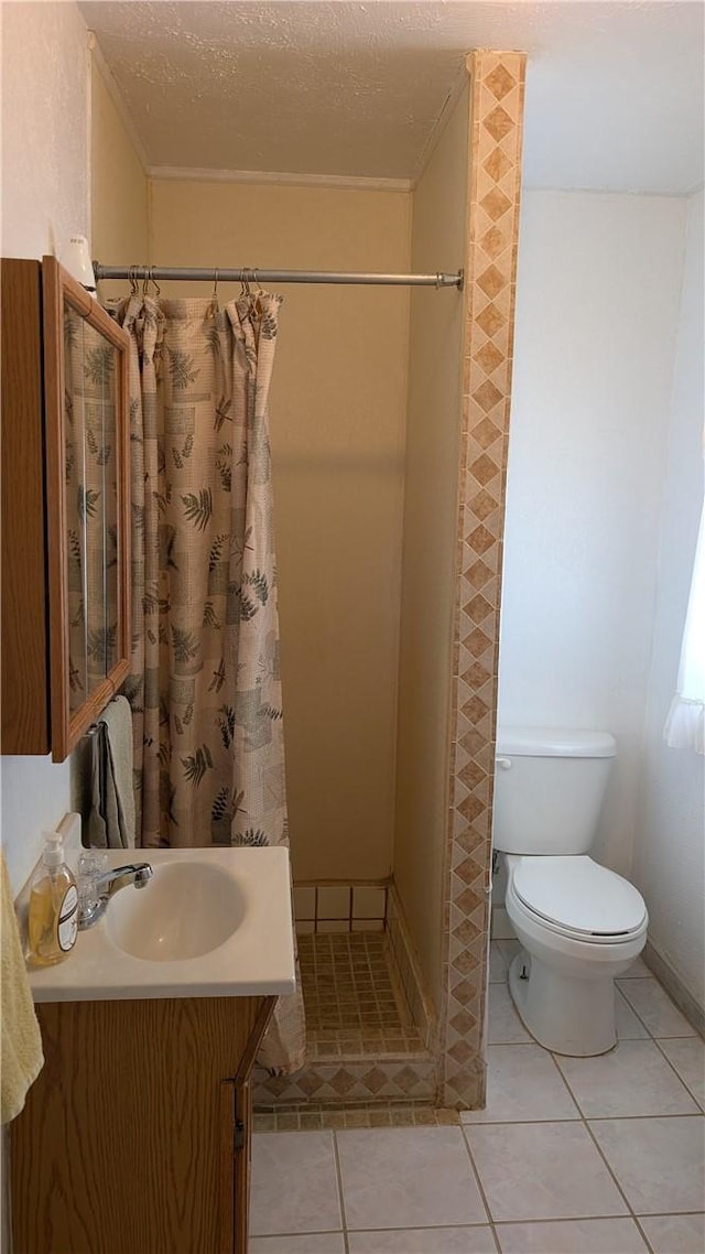 bathroom with toilet, a stall shower, tile patterned flooring, and vanity