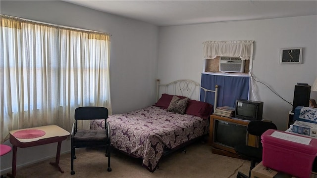 carpeted bedroom with cooling unit and multiple windows