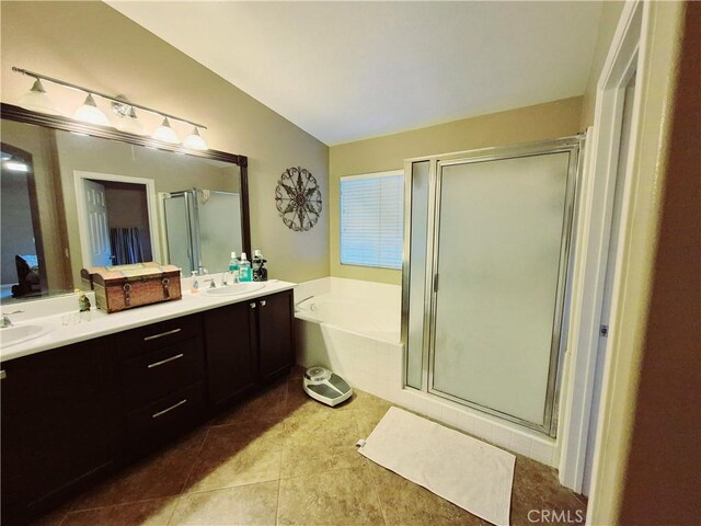 bathroom featuring lofted ceiling, a garden tub, a shower stall, and a sink