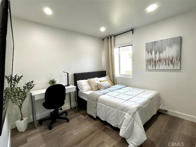 bedroom with wood finished floors, baseboards, and recessed lighting