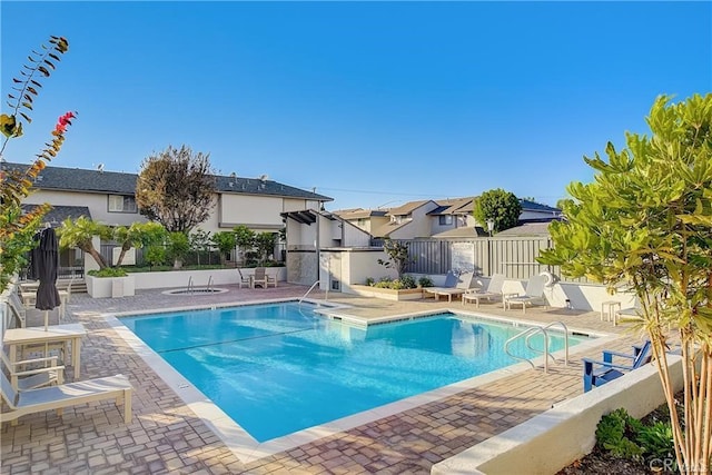 pool with fence and a patio