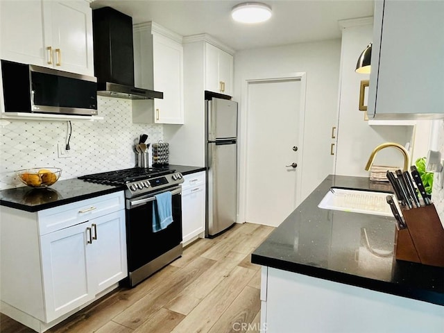 kitchen with exhaust hood, light wood finished floors, backsplash, stainless steel appliances, and white cabinets