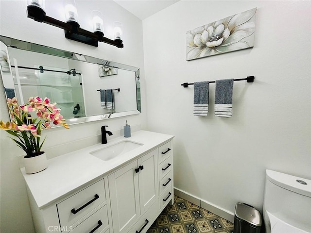 full bath featuring toilet, vanity, tile patterned floors, an enclosed shower, and baseboards