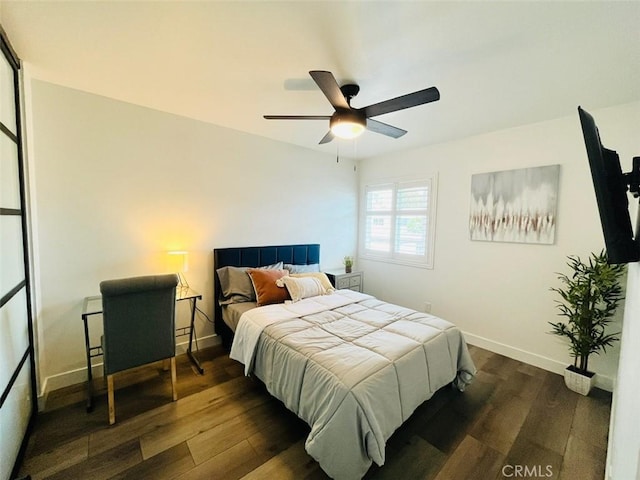 bedroom with dark wood finished floors, baseboards, and ceiling fan