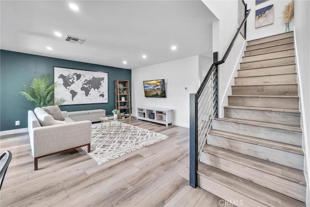 14142 Via Posada Unit 29, Tustin, CA 92780 - living area with stairs, recessed lighting, wood finished floors, and baseboards