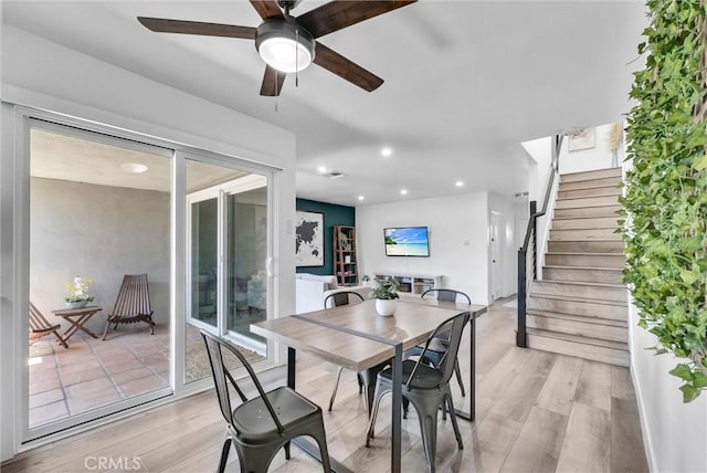 14142 Via Posada Unit 29, Tustin, CA 92780 - dining area with light wood-style flooring, ceiling fan, stairway, and recessed lighting