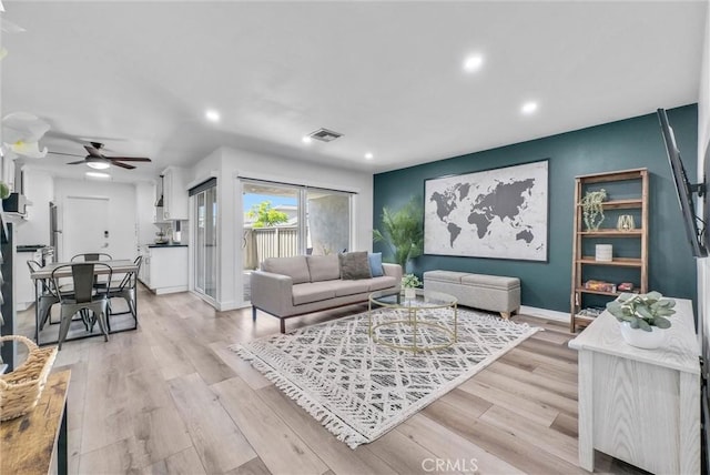 14142 Via Posada Unit 29, Tustin, CA 92780 - living room with recessed lighting, light wood-style floors, a ceiling fan, and baseboards
