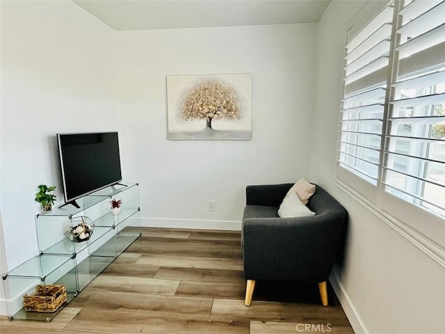 14142 Via Posada Unit 29, Tustin, CA 92780 - sitting room with wood finished floors and baseboards