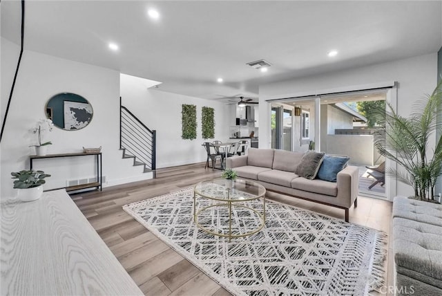 14142 Via Posada Unit 29, Tustin, CA 92780 - living area featuring stairway, recessed lighting, light wood-type flooring, and a ceiling fan