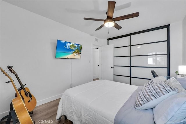 14142 Via Posada Unit 29, Tustin, CA 92780 - bedroom with wood finished floors and ceiling fan