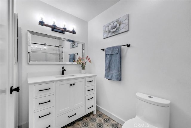 14142 Via Posada Unit 29, Tustin, CA 92780 - bathroom with baseboards, toilet, vanity, and tile patterned floors