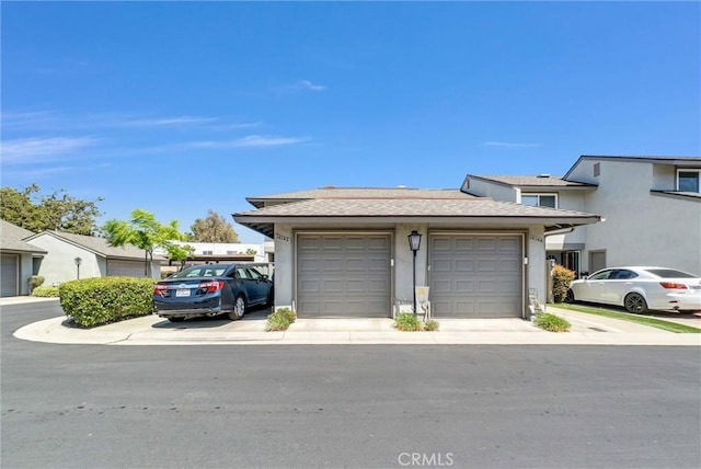 14142 Via Posada Unit 29, Tustin, CA 92780 - view of front of property with a garage and stucco siding