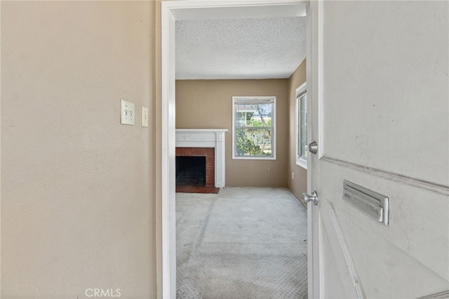 847 W 25th St, San Bernardino, CA 92405 - hallway with a textured ceiling and light colored carpet